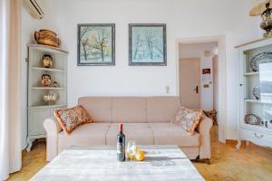 a living room with a couch and a table at Jelena Apartments By The Sea in Agios Nikolaos