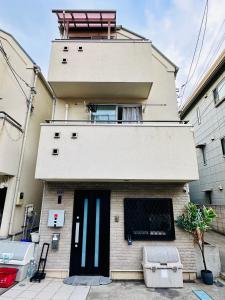 a building with a black door and a balcony at 100㎡ Cozy Villa in Shinjuku｜JR Shin-Ōkubo Sta. 7mins. in Tokyo