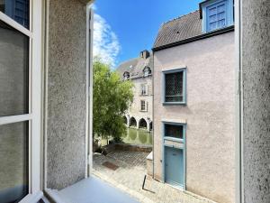 an open window with a view of a building at Au bord de l'Eure - Free parking in Chartres