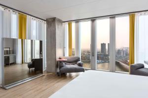 a living room with a view of a city at nhow Rotterdam in Rotterdam