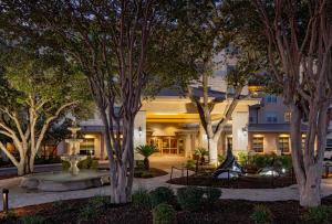 an exterior view of a building with trees at Hilton San Antonio Hill Country in San Antonio