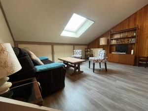 a living room with a couch and a table at LES ECRINS in Vallouise