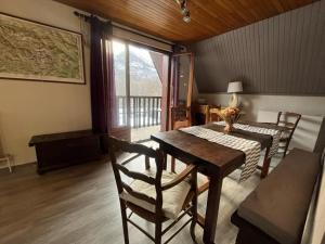 a dining room with a table and chairs and a window at LES ECRINS in Vallouise