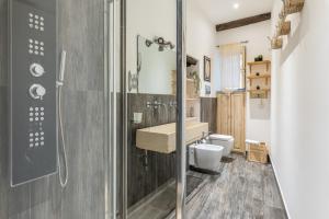 a bathroom with a shower and a sink and a toilet at Borsa Apartments by Wonderful Italy in Palermo +9 photos