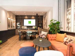 a living room with a couch and a table at Ibis Styles Hotel Paris Gare de Lyon Bastille in Paris