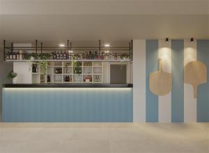 a bar with a blue wall and a shelf at Sauló By Puro in Can Pastilla