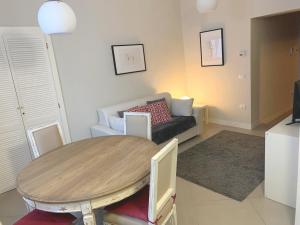 a living room with a table and a couch at "le Volte" Appartamento nel cuore di Foligno in Foligno