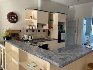 a kitchen with a large counter top in a room at Home in Church corner in Christchurch