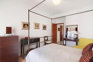 a bedroom with a bed and a dresser and a mirror at Apartamento Santos in Tavira +16 photos