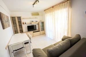 a living room with a couch and a table at Mar Azul Litoral - COSTA DORADA in Cambrils