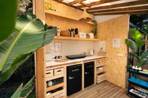 a kitchen with a counter in a building at Kampaoh Hostel El Palmar in El Palmar +18 photos