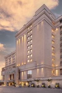 a large white building with lights on it at Steigenberger Hotel El Tahrir Cairo in Cairo