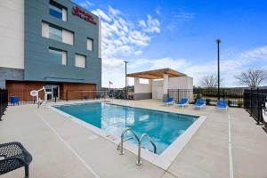 a swimming pool in front of a building at Hampton Inn & Suites Bessemer Birmingham in Bessemer