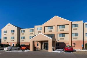 a large building with cars parked in a parking lot at AmericInn by Wyndham St Cloud MN Shopping Area in Saint Cloud