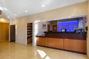 a lobby with a reception desk with a large screen at AmericInn by Wyndham St Cloud MN Shopping Area in Saint Cloud