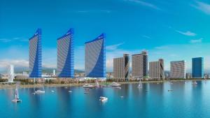 a group of tall buildings with boats in the water at Panorama Sea View Central City Batumi & ApartHOTEL in Batumi