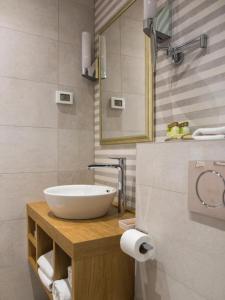 a bathroom with a white sink and a mirror at Tailor Apartment with a Private Terrace in Dubrovnik