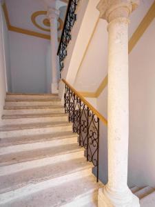 a staircase in a house with a column at Tailor Apartment with a Private Terrace in Dubrovnik