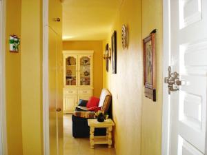 a hallway with a couch and a chair in a room at Minerva Jupiter Apartments in Benalmádena