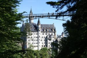 a castle on a mountain with a bridge over it at Ferienwohnung Vera in Schwangau +10 photos