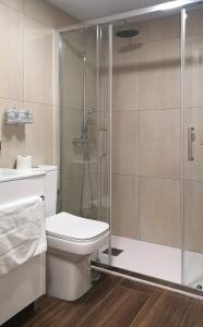 a bathroom with a toilet and a glass shower at El Indio Chocolatería Boutique in Pinto