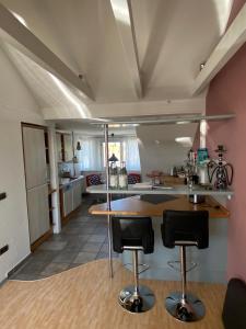 a kitchen with a counter and two bar stools at Kays Home in Bad Wörishofen