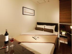 Postel nebo postele na pokoji v ubytování Hotel UNO Nishikawaguchi Nishiguchi