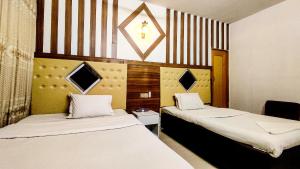 a room with two beds in a room at White Rose Suites Ltd in Dhaka