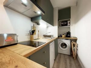 a kitchen with a sink and a washing machine at Le Floral - Parking - Self check in in Chartres