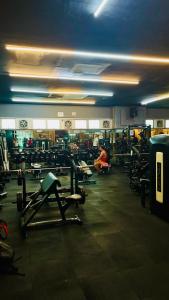 a gym with lots of machines and people in it at 2 Bedroom Condo in the center of MM in Manila