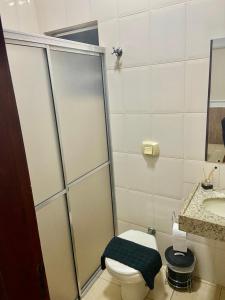 a bathroom with a shower and a toilet and a sink at HOTEL ROCHA - Olímpia in Olímpia