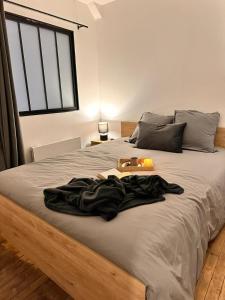a bed with a blanket on it with a tray on it at Appartement Couteliers-Centre ville-4pers in Moulins
