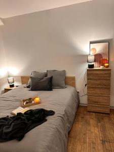 a bedroom with a bed with a tray on it at Appartement Couteliers-Centre ville-4pers in Moulins