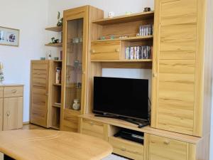 a large wooden entertainment center with a flat screen tv at Bernhard Schmidt-Gasse in Gmunden