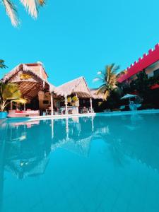 a swimming pool in front of a resort at Hotel de Charme Castelinho in Canoa Quebrada