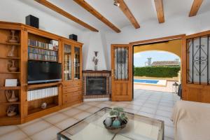a living room with a tv and a fireplace at Villa Escudero - Plusholidays in Calpe