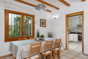 a kitchen and dining room with a table and chairs at Villa Escudero - Plusholidays in Calpe
