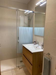 a bathroom with a sink and a shower with a mirror at Villa Costa Antigua Piscina in Costa de Antigua