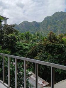 a balcony with a view of trees and mountains at Forest Bay Inn El Nido in El Nido