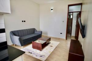 a living room with a couch and a coffee table at ATA Lux Apartments in Kira