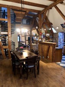 a dining room with a wooden table and chairs at Eschachblick in Zimmern ob Rottweil