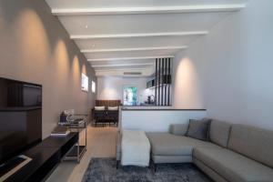 a living room with a couch and a television at Atelierhaus in Dresden Loschwitz in Dresden