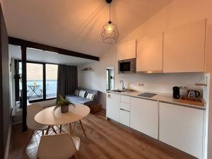 a kitchen and living room with a table and chairs at Penthouse + Terrace in Estrecho - En 20 in Madrid