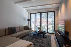 a living room with a couch and a large window at Atelierhaus in Dresden Loschwitz in Dresden