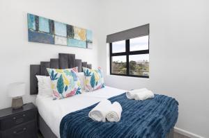 a bedroom with a bed with towels on it at Atlantic Port 9 in Bloubergstrand