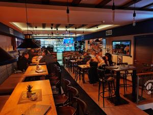 a restaurant with people sitting at tables in a room at Ogi & Una Premijer 42 in Kopaonik