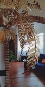 a large potted plant in a living room at Posada Puente Romano in Sedella