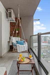 a plate of fruit on a table on a balcony at Mido Park Apartment with Private Parking in Bucharest