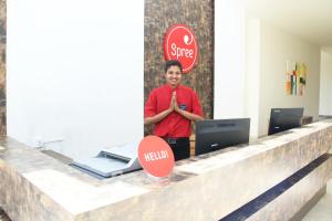 a boy standing at a counter with a stop sign at Spree Resort At Century Wintersun in Dod Ballāpur