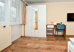 a living room with a desk and a chair at Palmy Apartmanhouse Maglód in Maglód